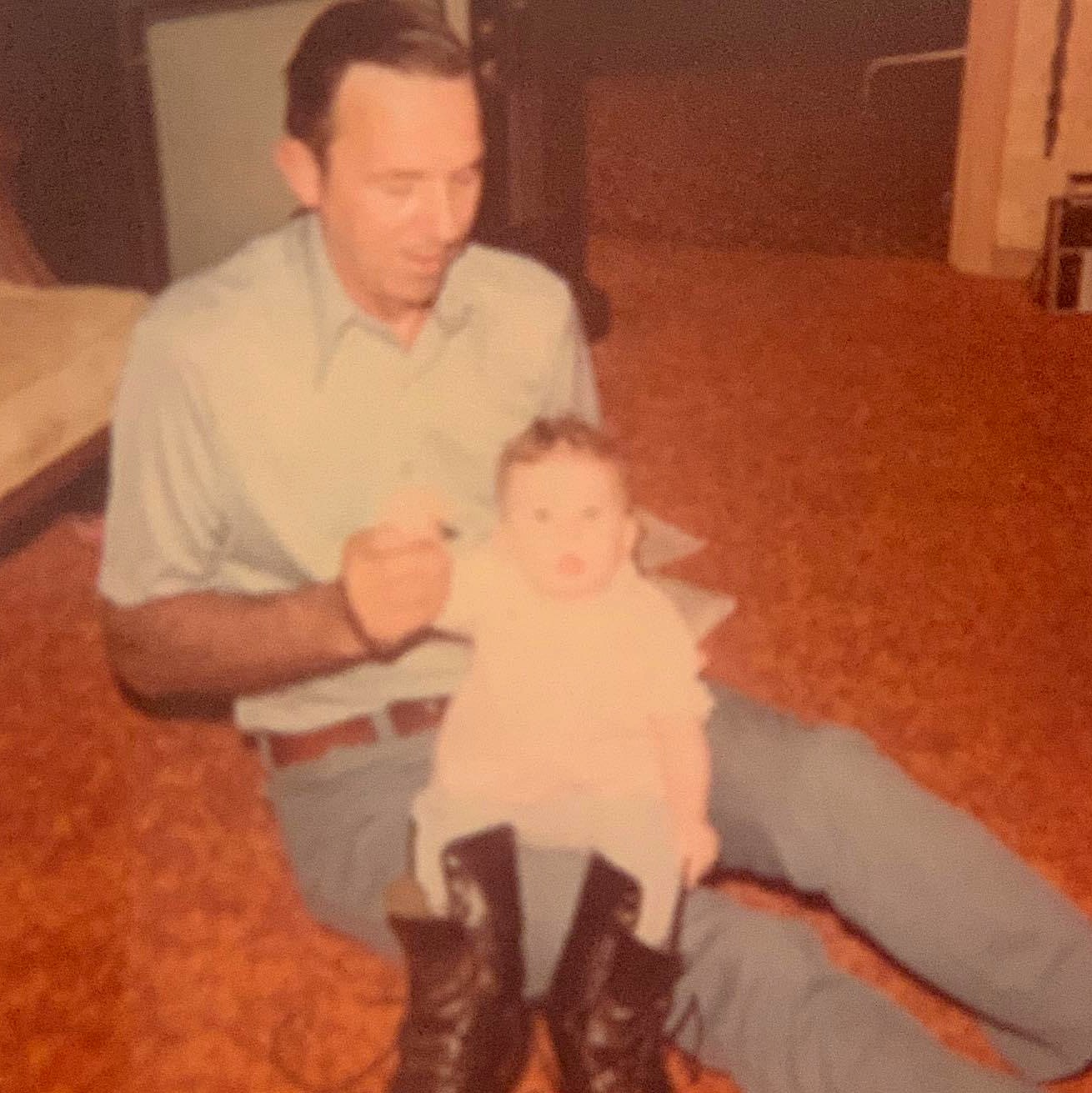 Holly as a baby with her grandfather